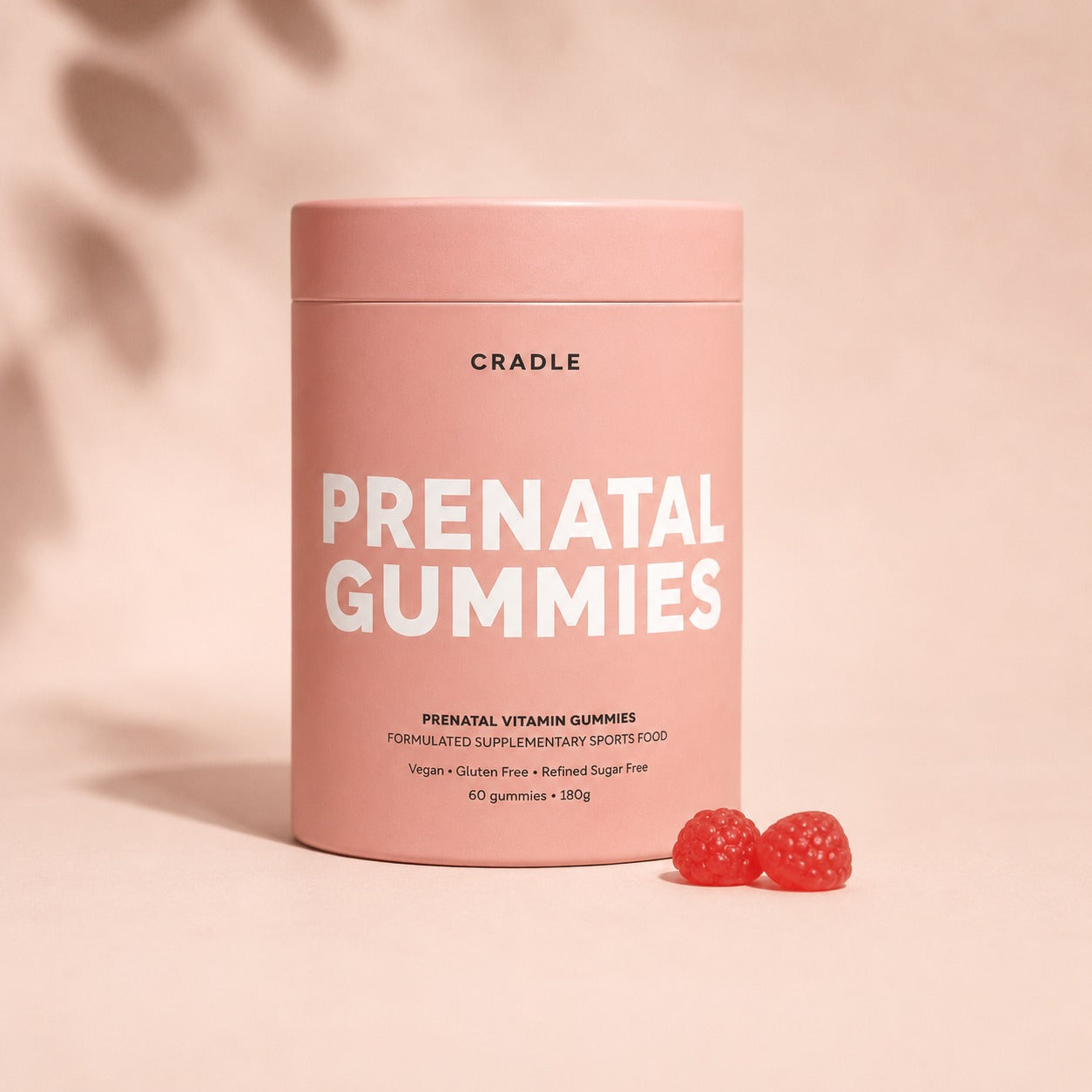 Product image — Bottle of Cradle Prenatal Multivitamin Gummies with 2 gummies beside it.